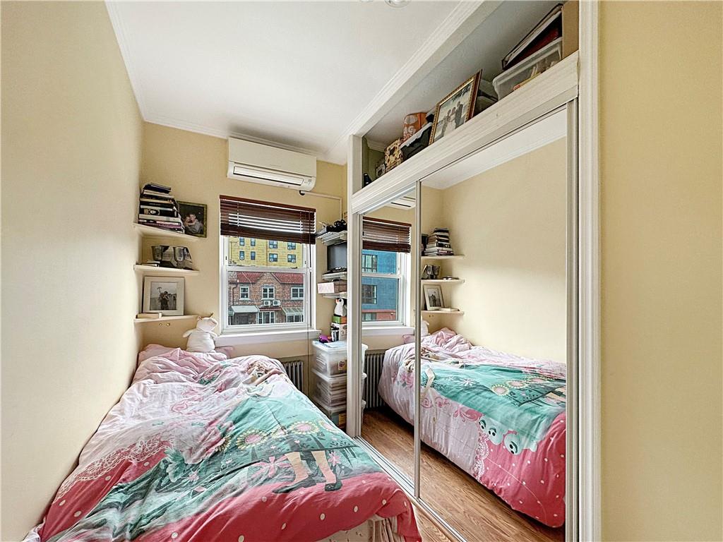 18 Corbin Place Brooklyn, NY 11235 - Photo 14 of 22 a bedroom with furniture and a large window