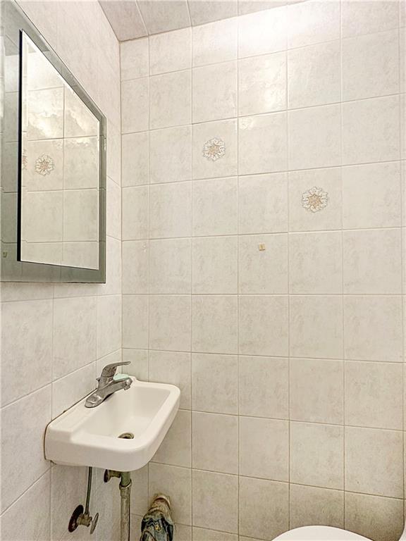 18 Corbin Place Brooklyn, NY 11235 - Photo 17 of 22 a bathroom with a sink a mirror and a shower