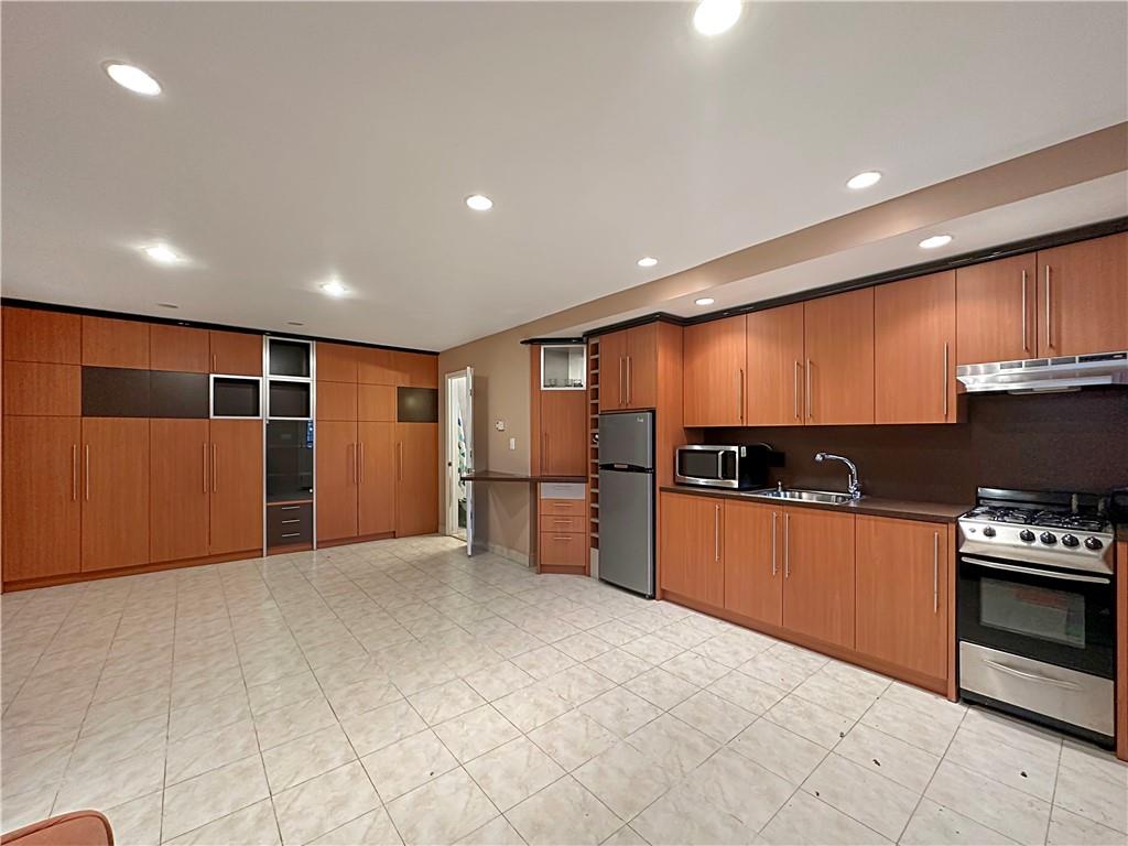 18 Corbin Place Brooklyn, NY 11235 - Photo 18 of 22 a kitchen with stainless steel appliances a refrigerator and a stove top oven
