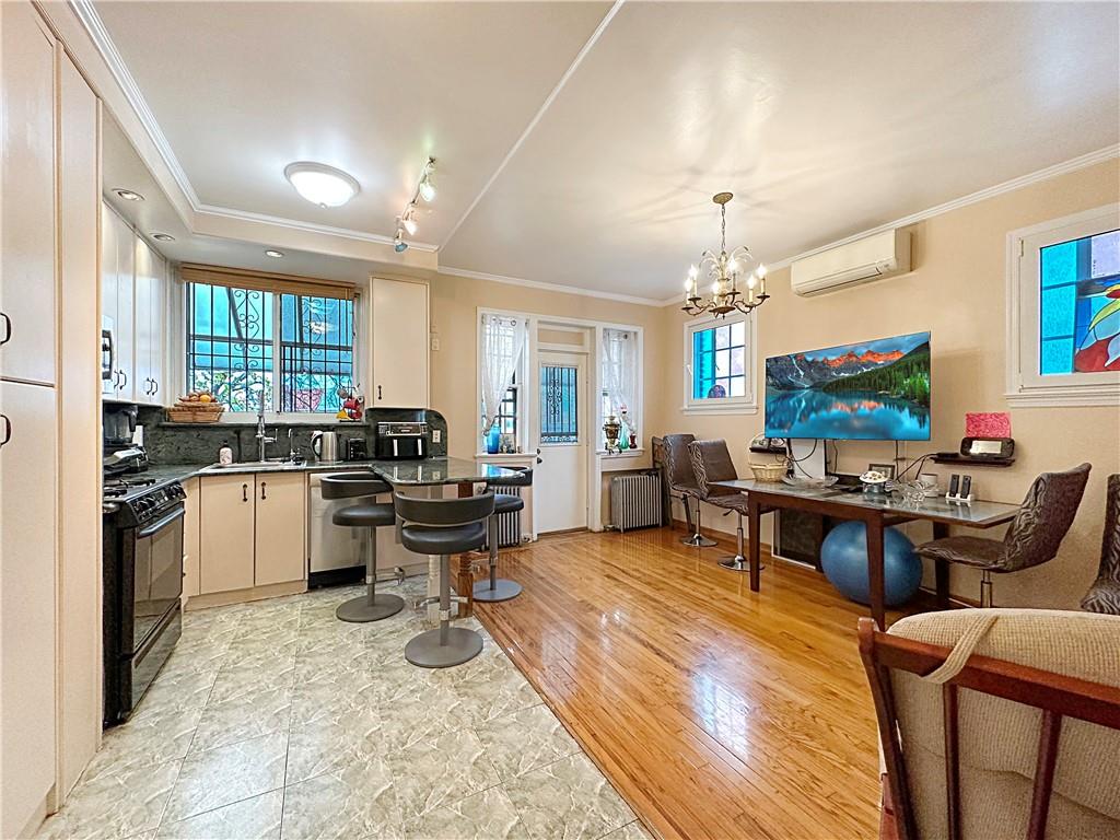 18 Corbin Place Brooklyn, NY 11235 - Photo 3 of 22 a kitchen that has a lot of cabinets a sink and a stove in it