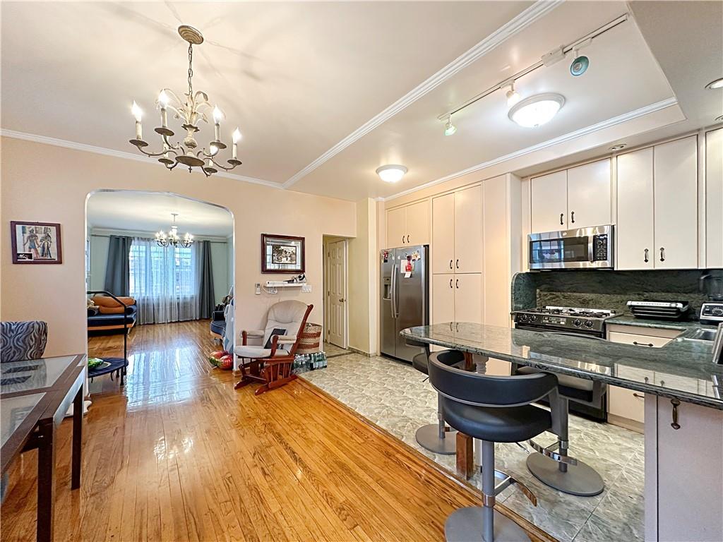 18 Corbin Place Brooklyn, NY 11235 - Photo 4 of 22 a living room with furniture and a chandelier