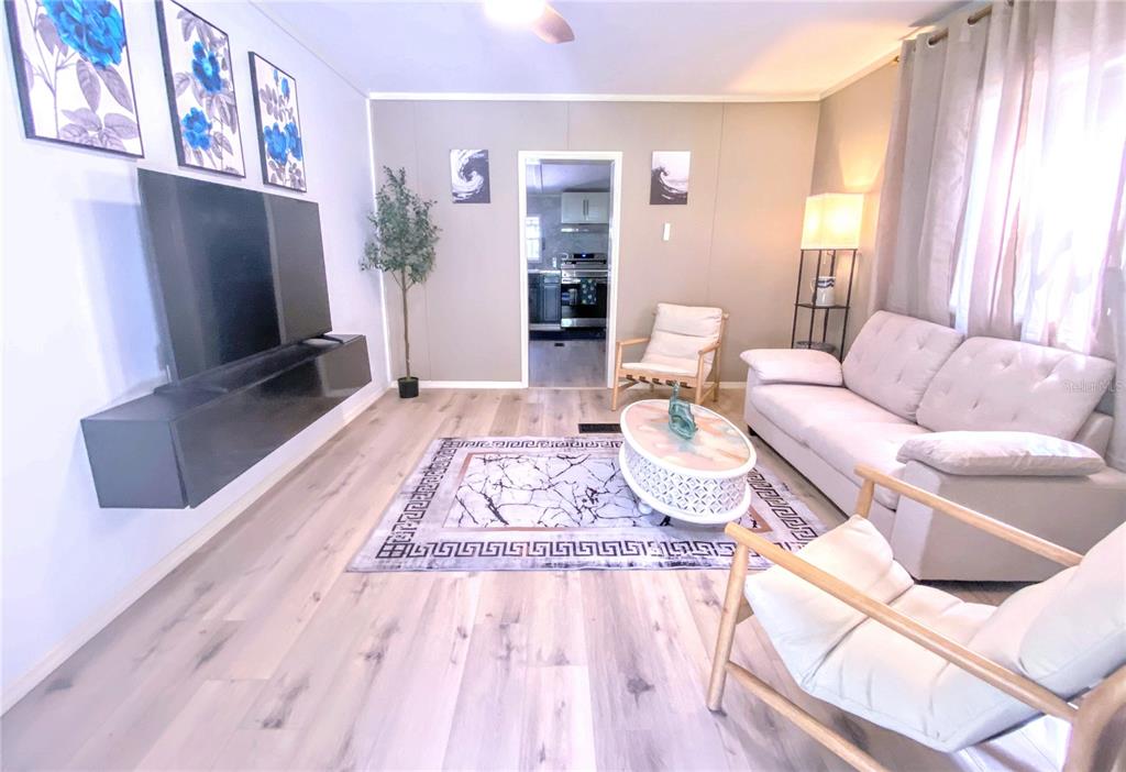 208 Ashley Street Hawthorne, FL 32640 - Photo 6 of 32 a living room with furniture and a flat screen tv