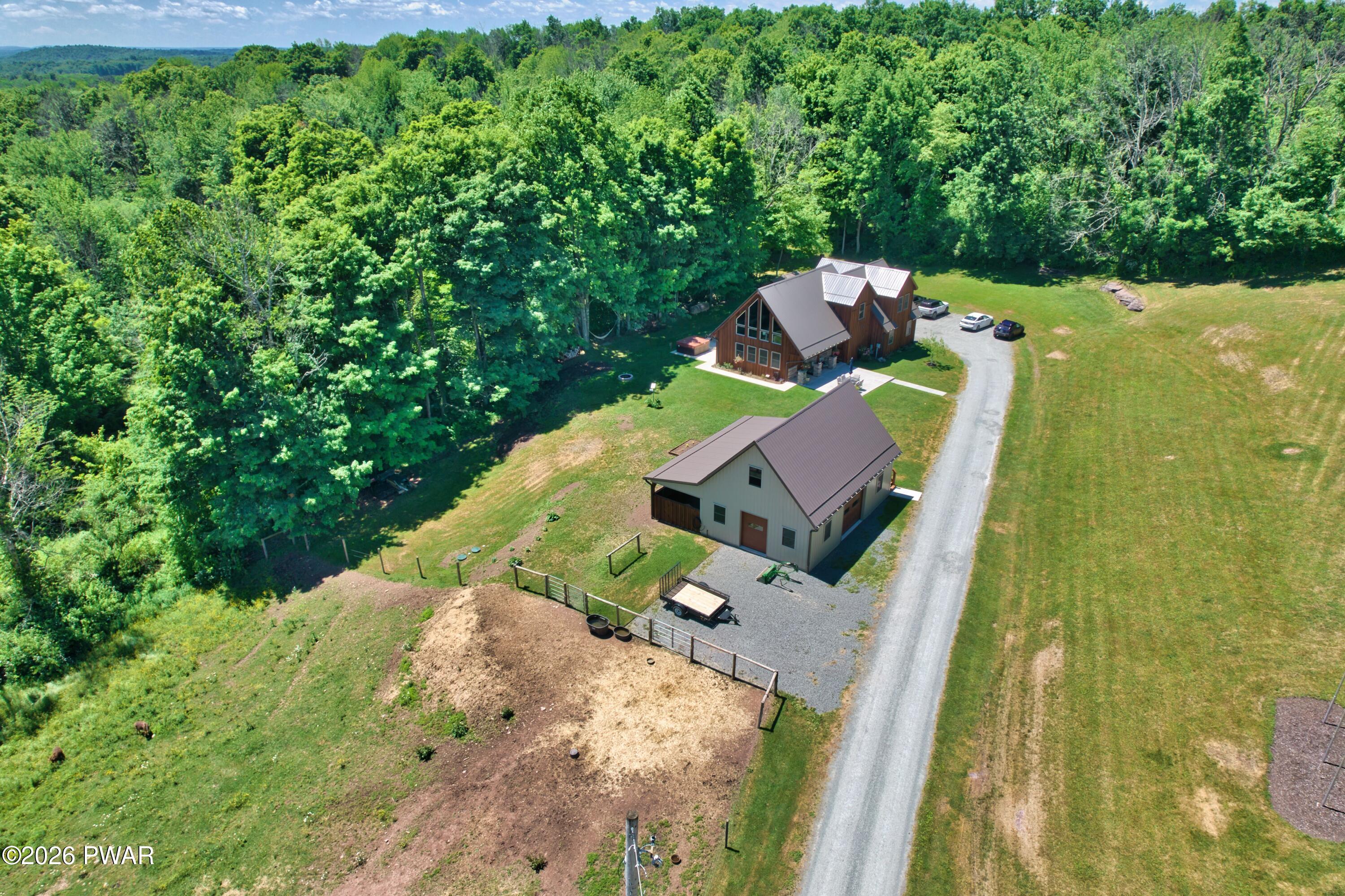 149 Sheards Road Milanville, PA 18443 - Photo 52 of 57 an aerial view of a house with outdoor space pool seating area and yard