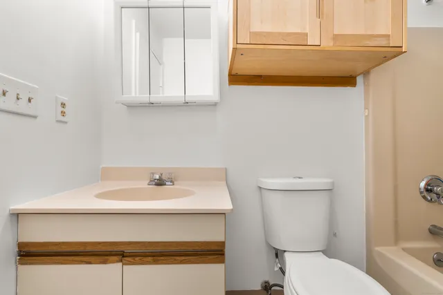 a bathroom with a sink a toilet and mirror