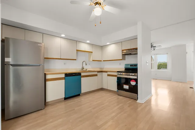 a kitchen with a refrigerator and a sink