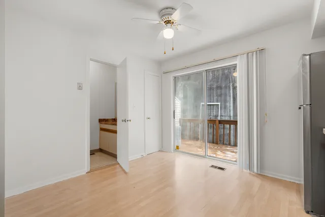 a view of a room with an empty space and a ceiling fan