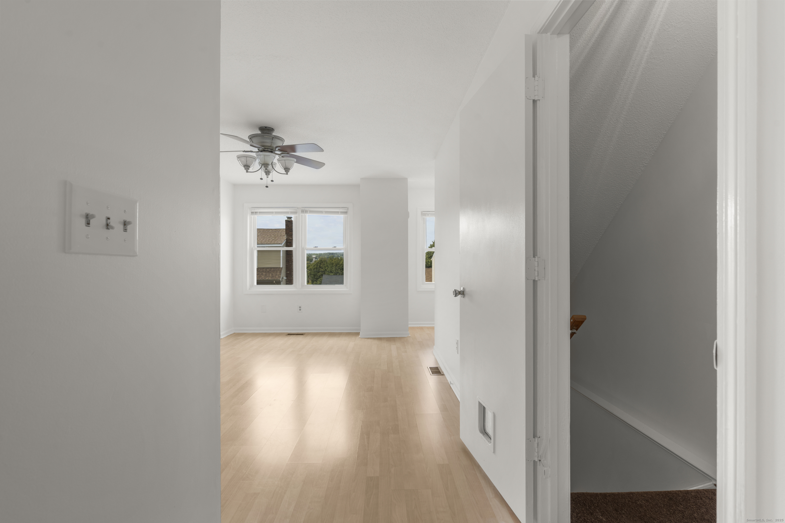 233 Derby Avenue, Unit 611 Derby, CT 06418 - Photo 6 of 19 a view of a hallway with a window and wooden floor
