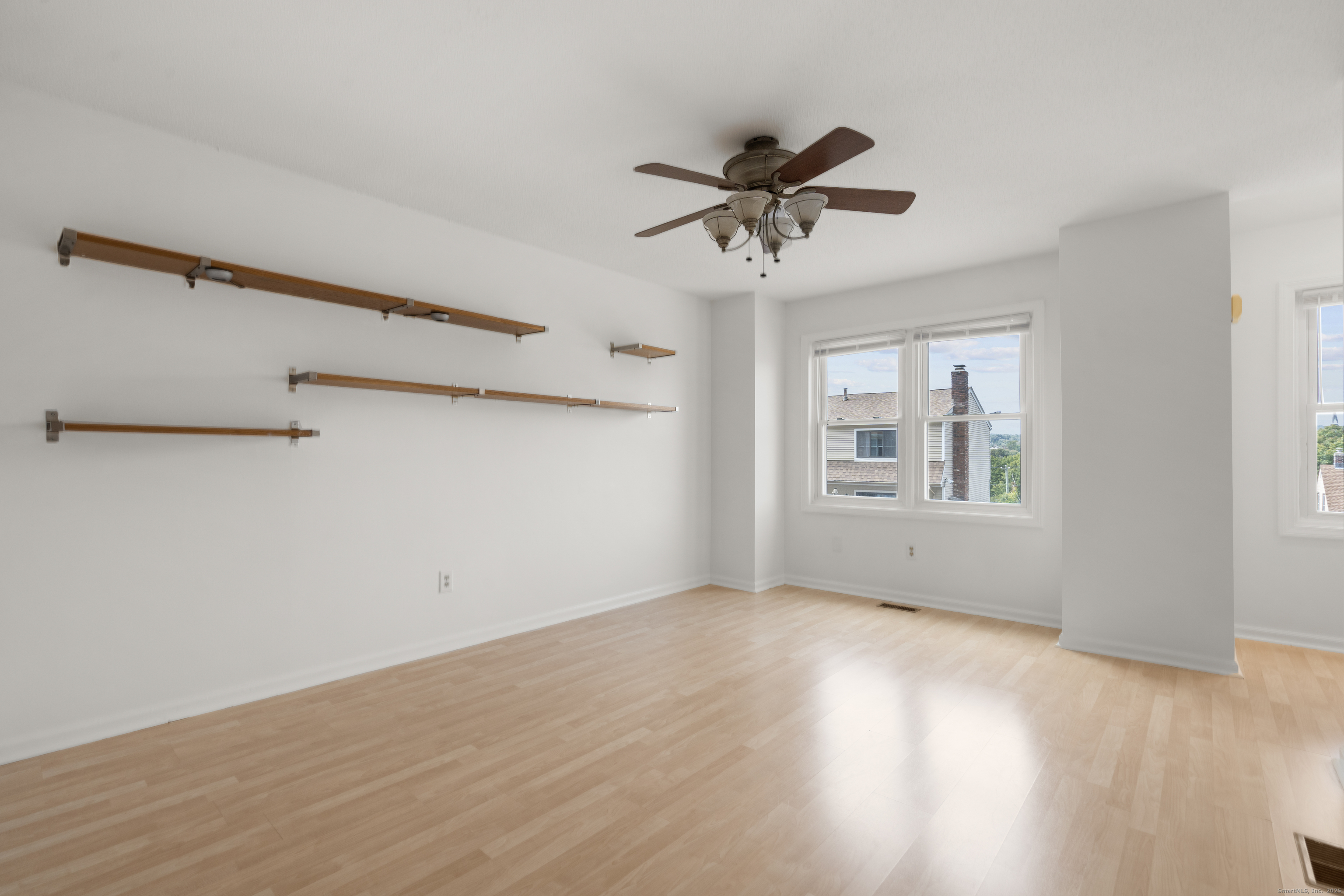 233 Derby Avenue, Unit 611 Derby, CT 06418 - Photo 7 of 19 a view of an empty room with a window and wooden floor