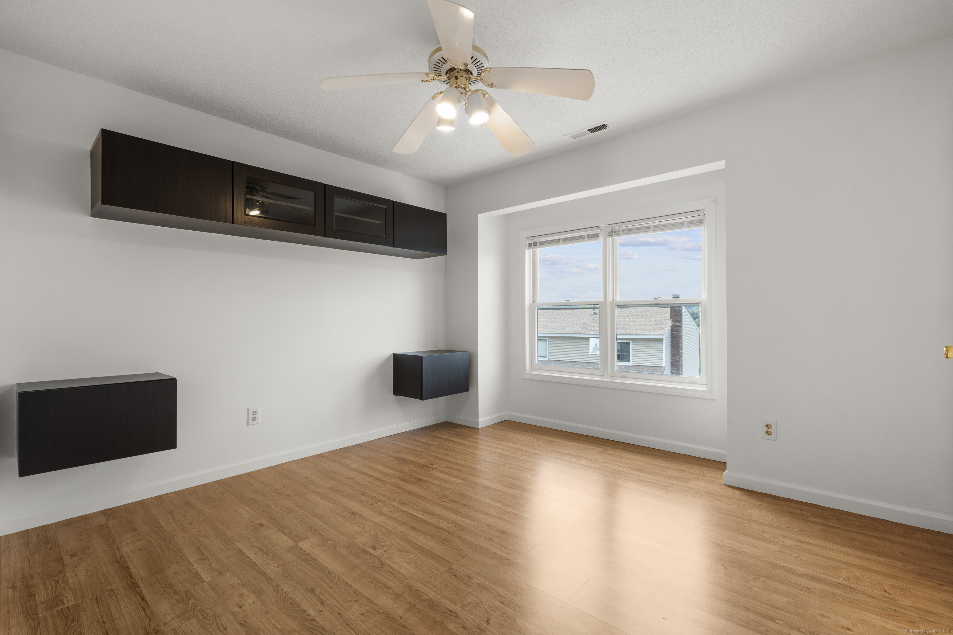 233 Derby Avenue, Unit 611 Derby, CT 06418 - Photo 8 of 19 a view of empty room with wooden floor and fan