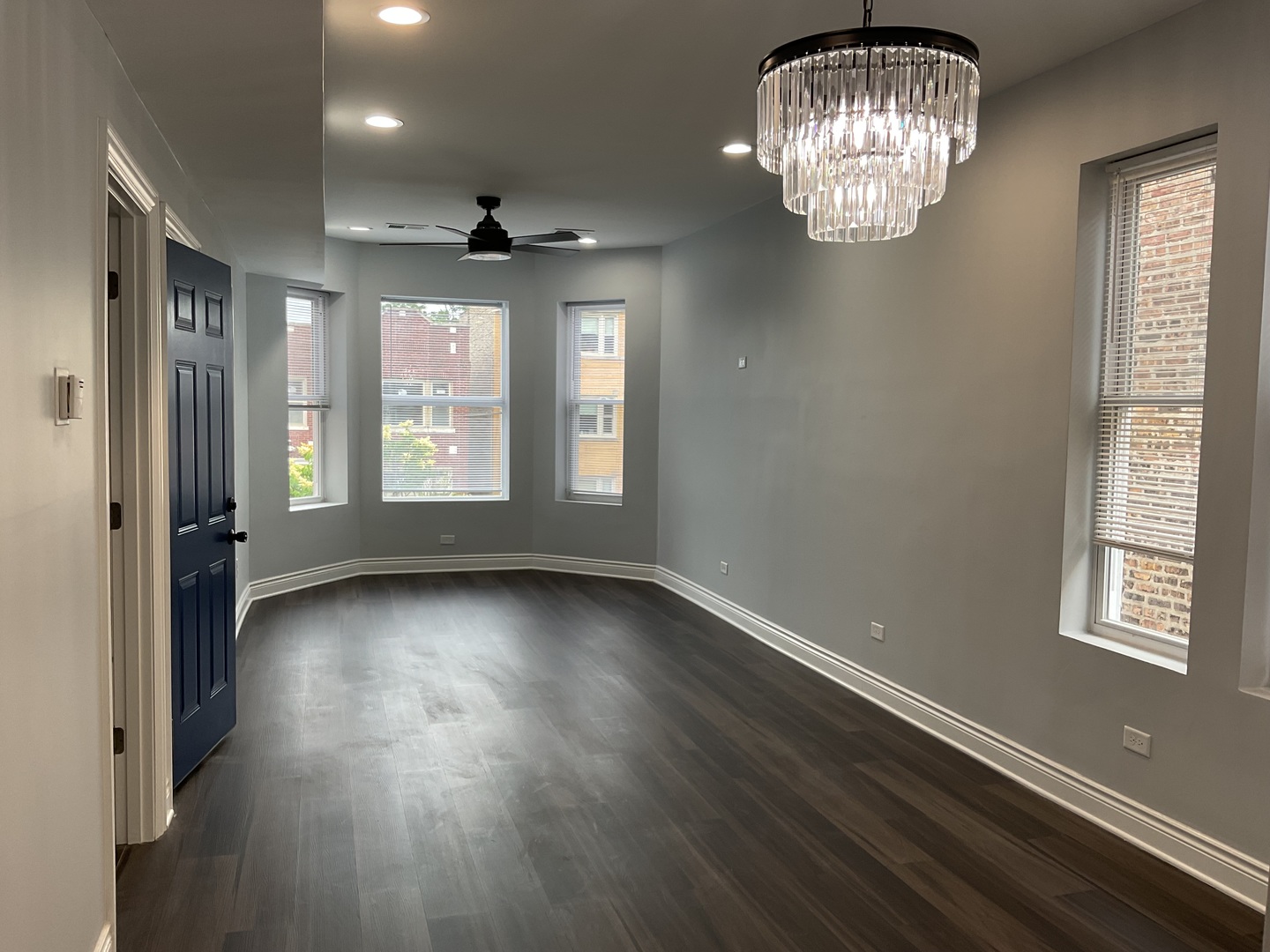 7940 South Carpenter Street, Unit 2 Chicago, IL 60620 - Photo 10 of 34 an empty room with wooden floor and windows