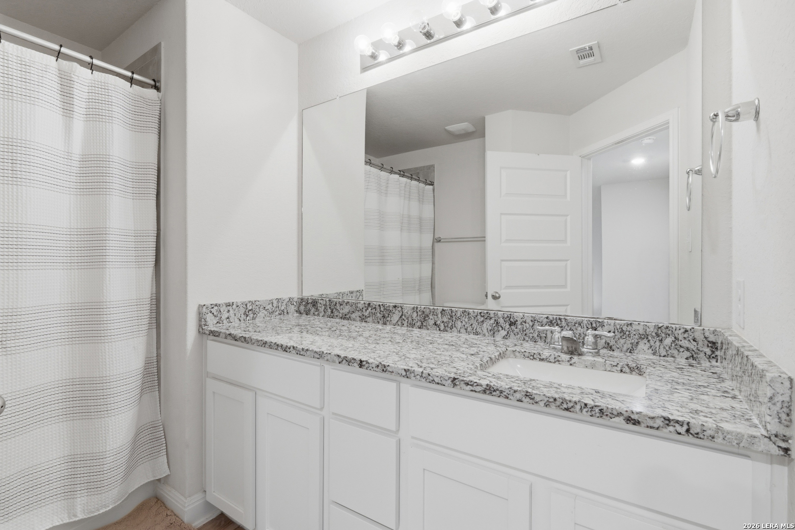 3511 Bronzed Copper Bulverde, TX 78163 - Photo 20 of 25 a bathroom with a granite countertop sink and a mirror