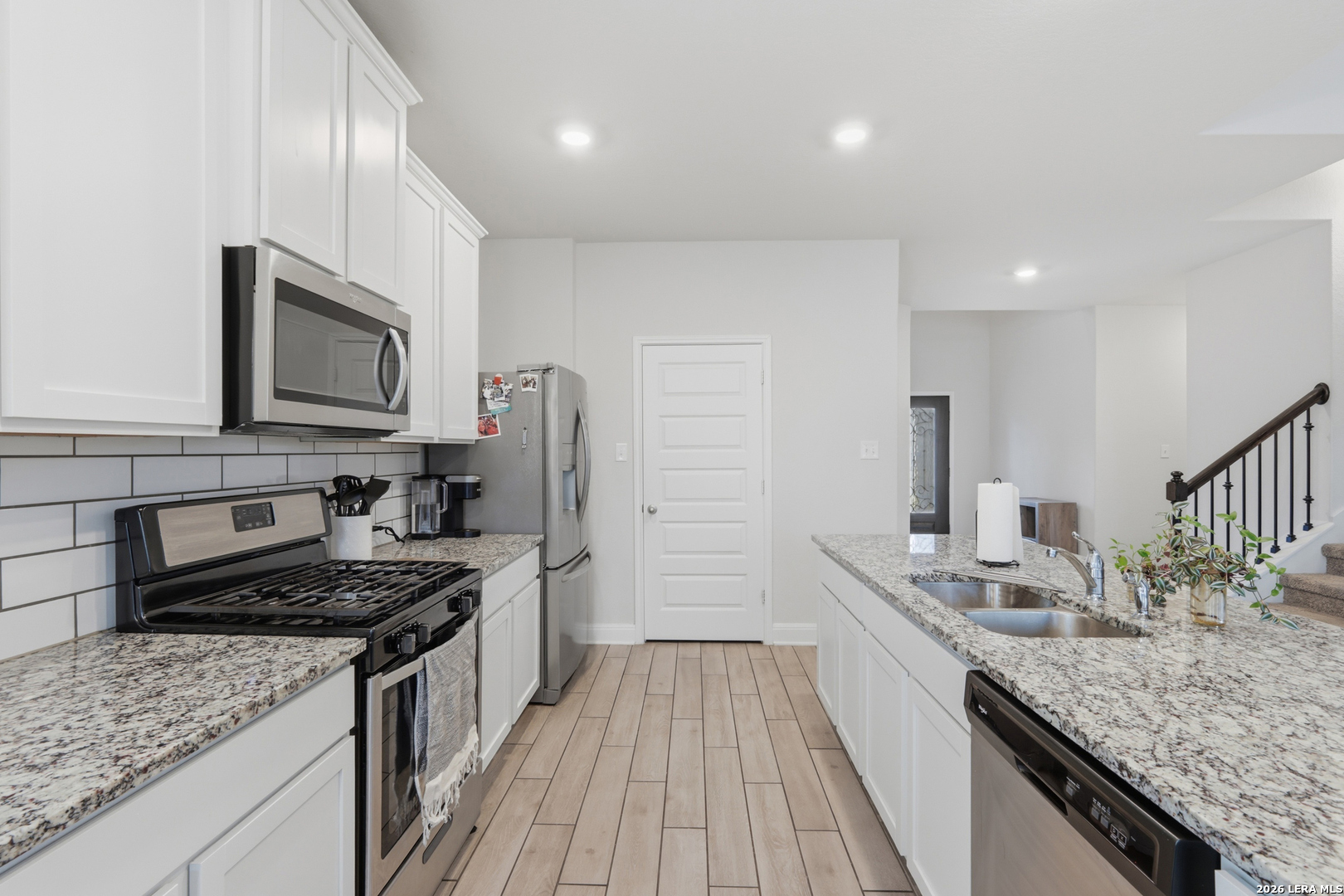 3511 Bronzed Copper Bulverde, TX 78163 - Photo 6 of 25 a kitchen with stainless steel appliances granite countertop a sink stove and refrigerator