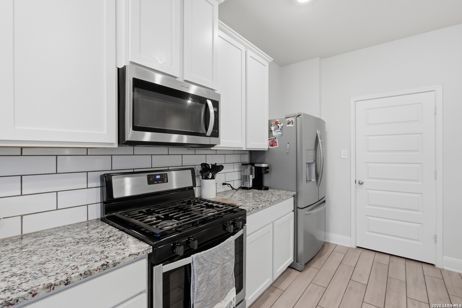 3511 Bronzed Copper Bulverde, TX 78163 - Photo 8 of 25 a kitchen with a stove and a microwave
