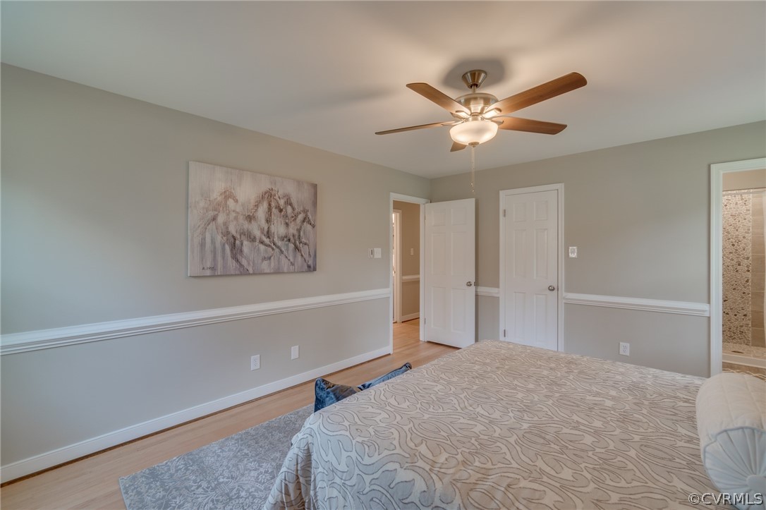 3908 Dunraven Road Chesterfield, VA 23236 - Photo 27 of 44 a bedroom with a bed and a chandelier