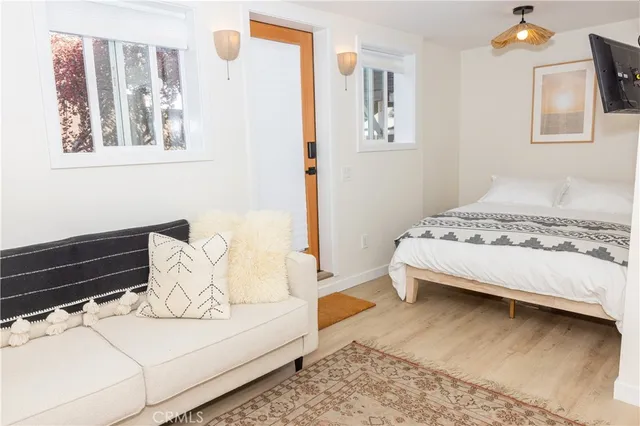 a bedroom with a bed and wooden floor