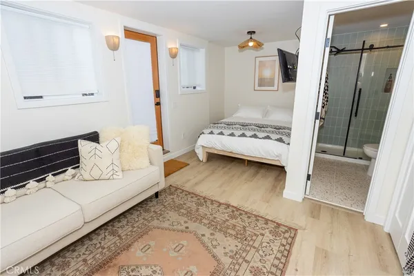 a bedroom with a bed and a large window