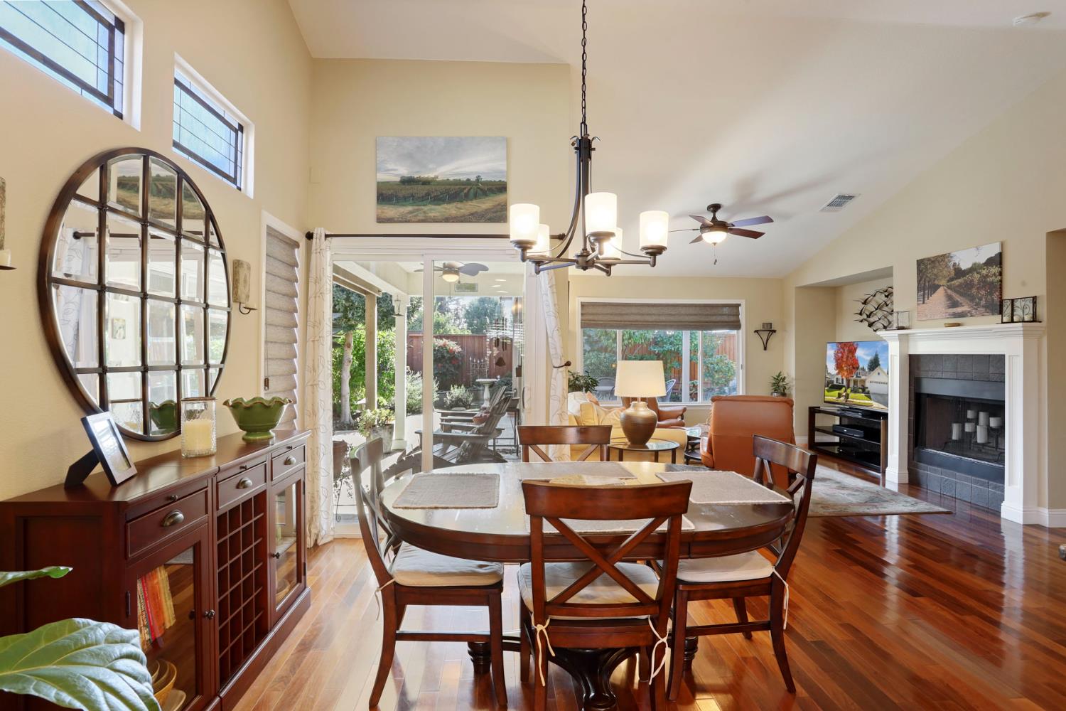 2832 Remington Way Tracy, CA 95377 - Photo 15 of 67 a view of a dining room with furniture a chandelier and wooden floor