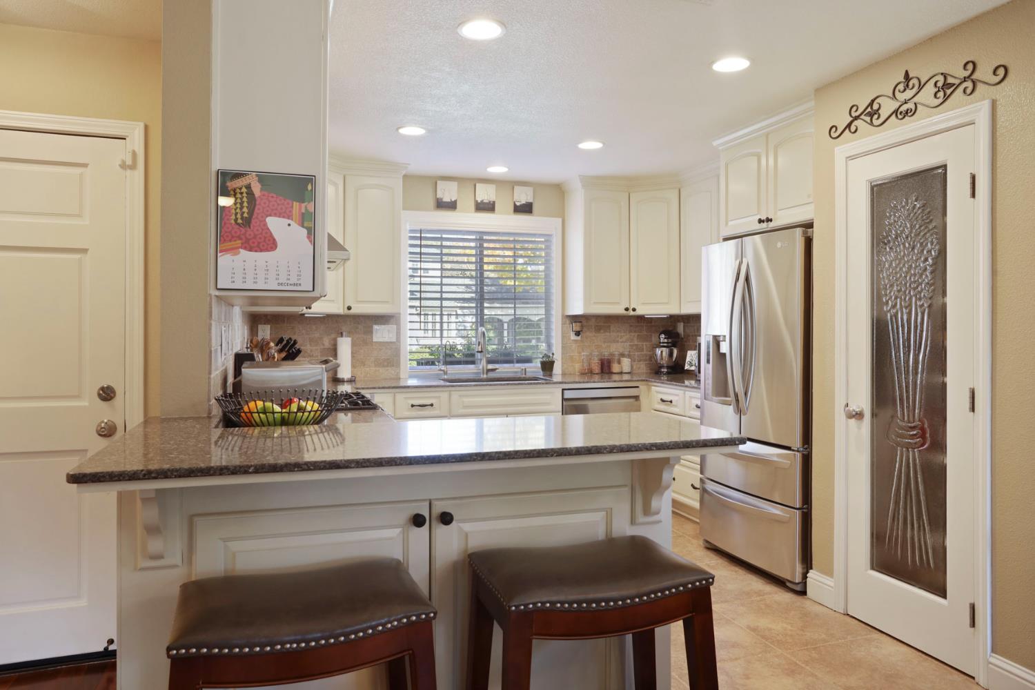 2832 Remington Way Tracy, CA 95377 - Photo 17 of 67 a kitchen with a refrigerator a sink and cabinets