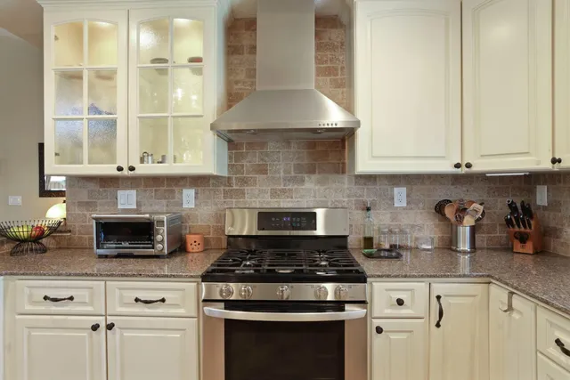 a bedroom with a bed and painting on the wall