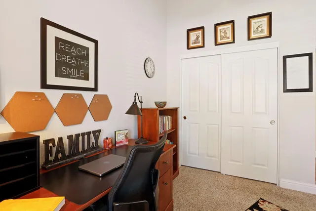 a spacious bedroom with a large bed and a chandelier