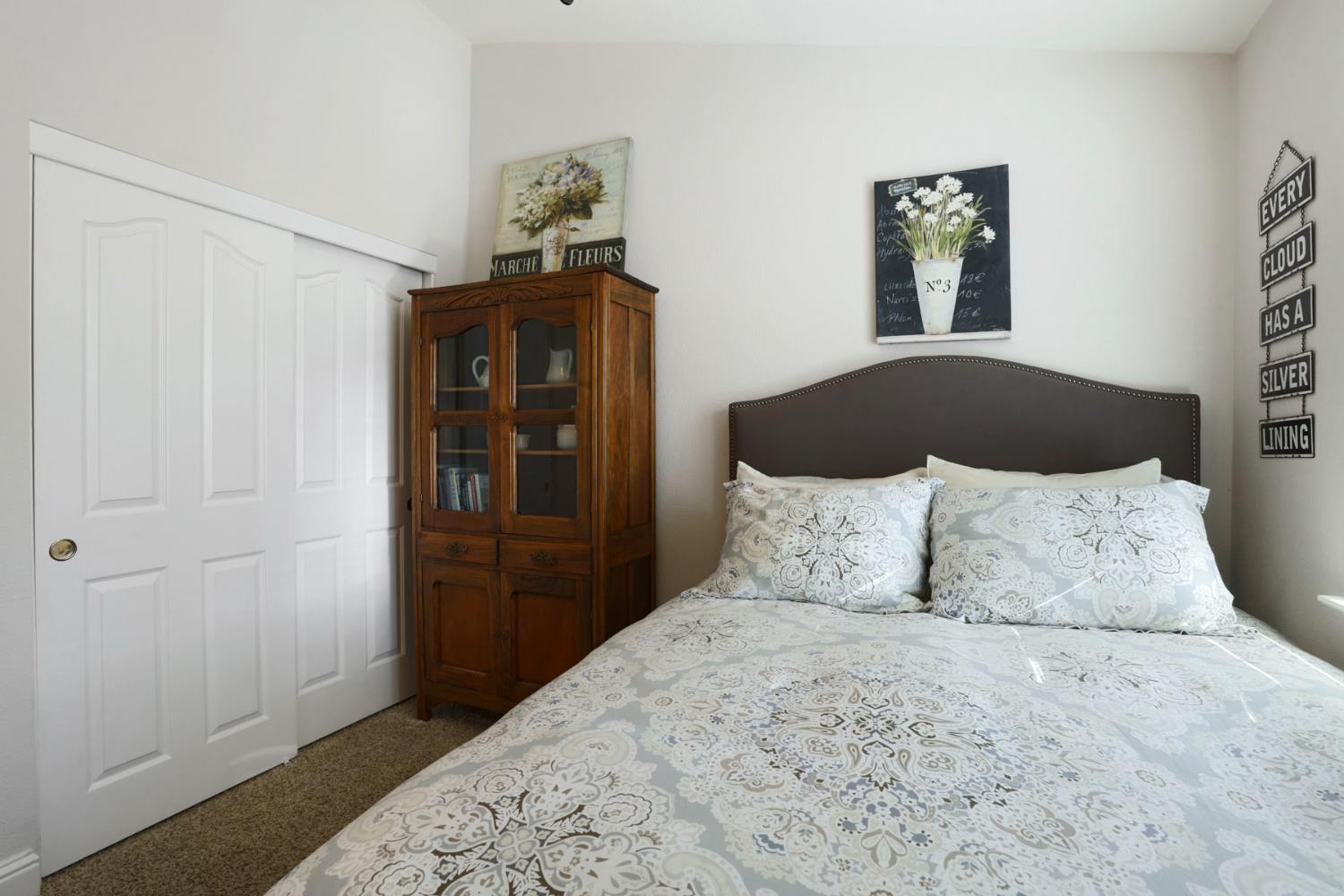 2832 Remington Way Tracy, CA 95377 - Photo 26 of 67 a bedroom with a bed and painting on the wall