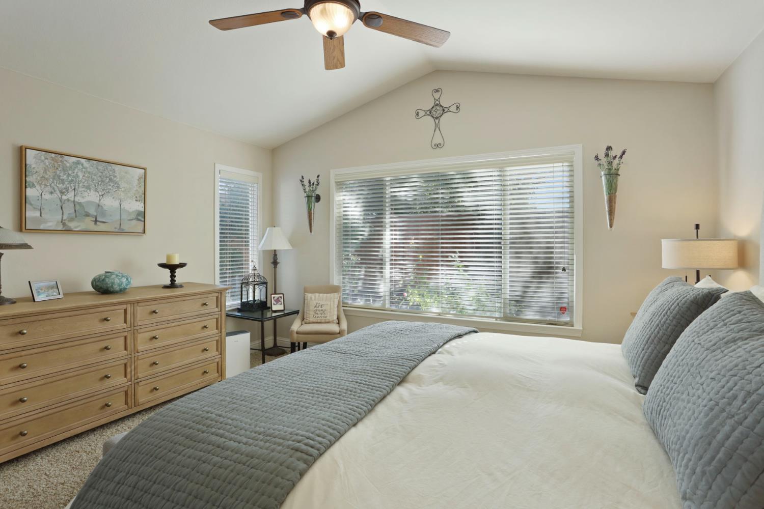 2832 Remington Way Tracy, CA 95377 - Photo 30 of 67 a spacious bedroom with a large bed and a chandelier
