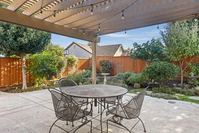 a view of a house with brick walls and a yard with plants