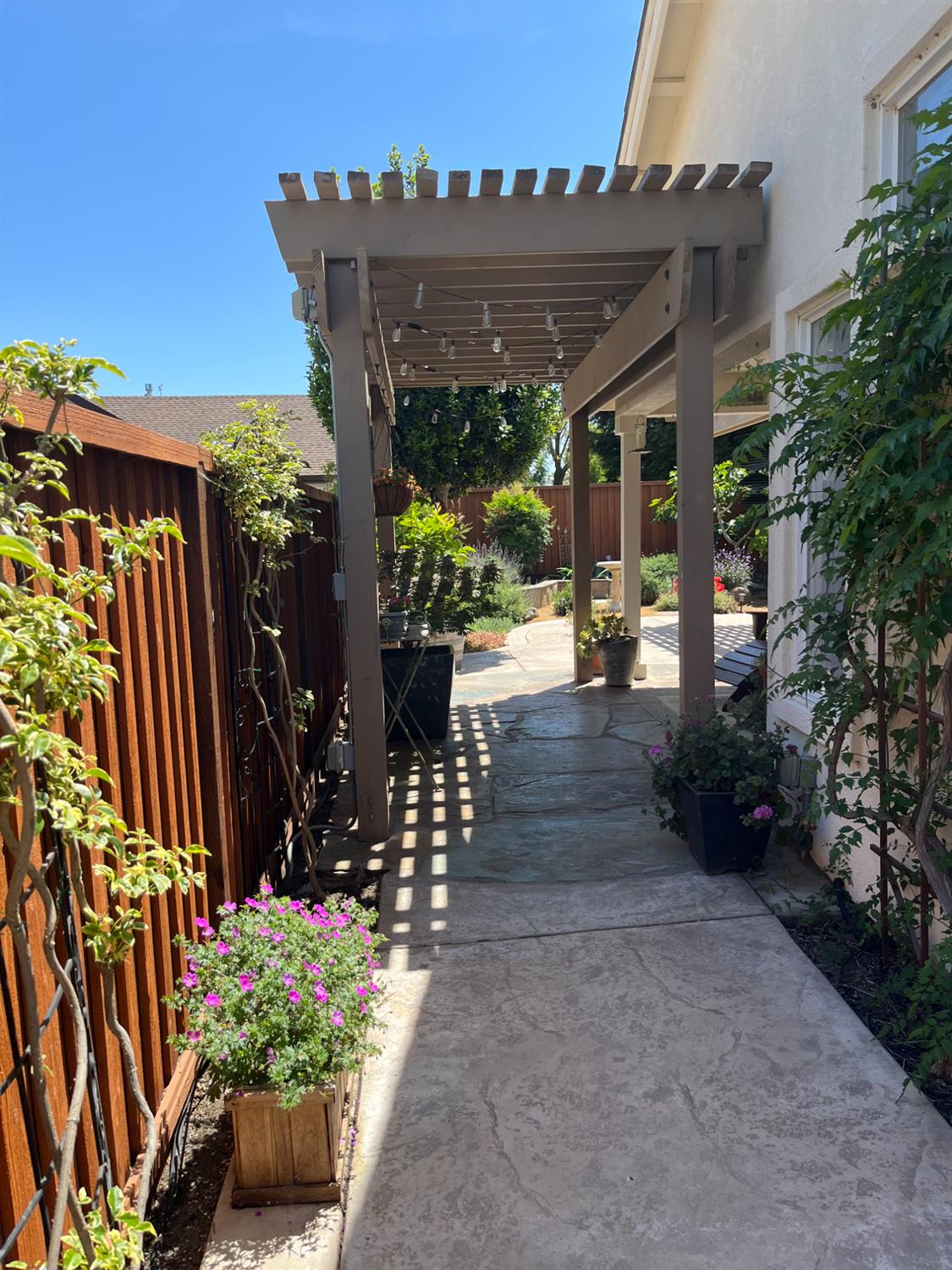 2832 Remington Way Tracy, CA 95377 - Photo 56 of 67 a view of a patio with table and chairs potted plants