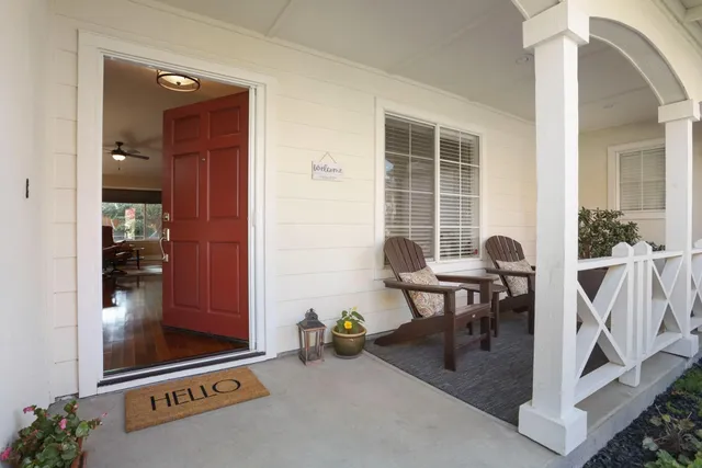 a living room with fireplace furniture and a large window
