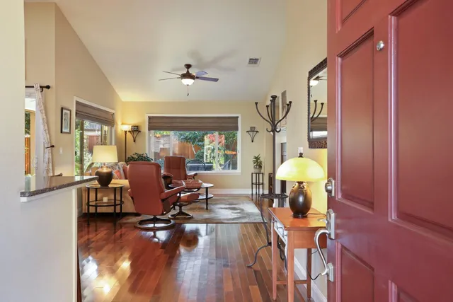 a dining room with furniture and wooden floor