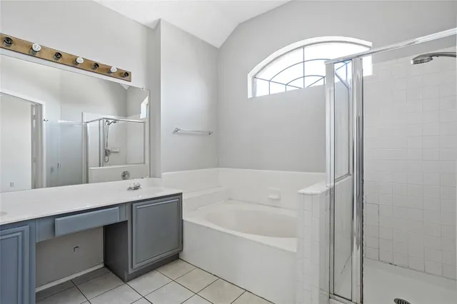 a bathroom with a tub sink and mirror