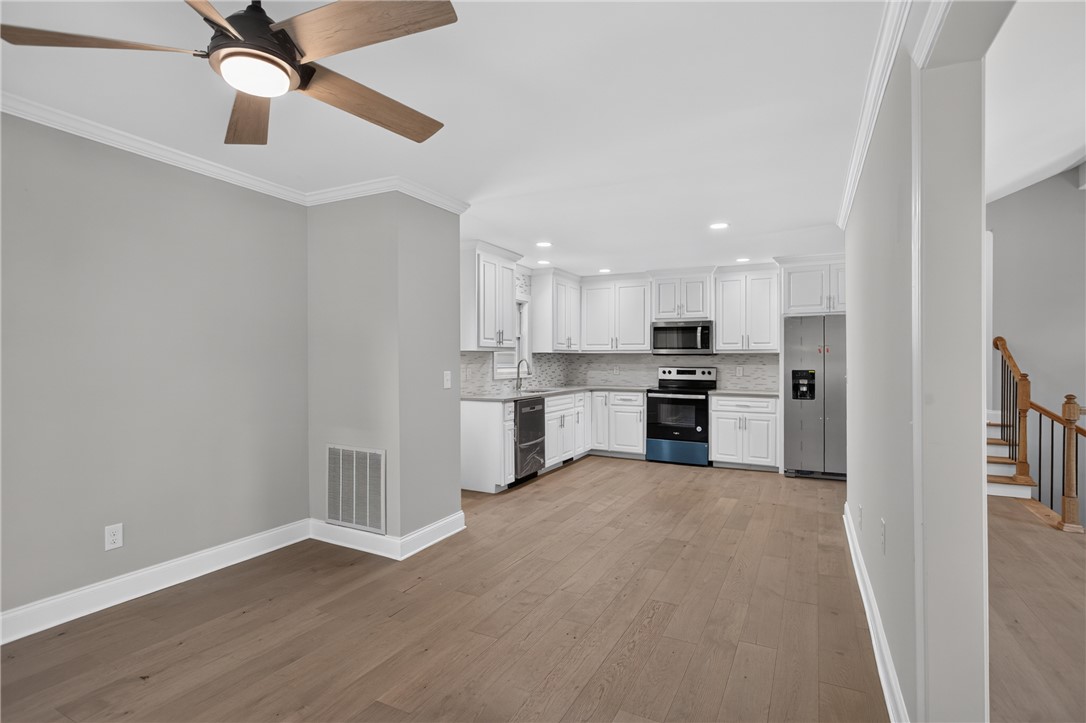 712 Beech Drive Seneca, SC 29678 - Photo 18 of 41 An open-concept living space presents a well-appointed kitchen flowing into a dining area with hardwood floors.