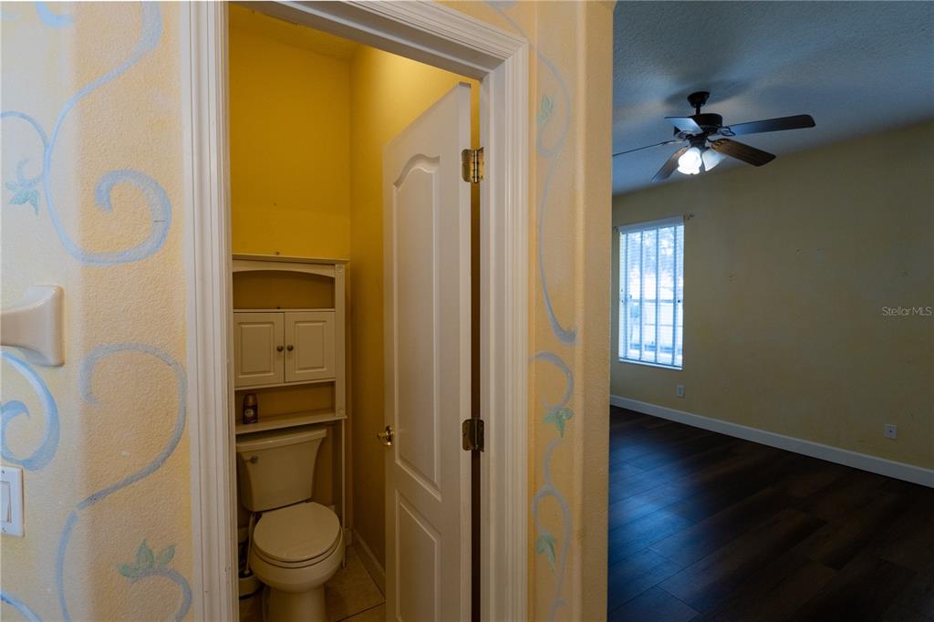 65 Calliope Street Ocoee, FL 34761 - Photo 20 of 60 a bathroom with a toilet a sink and shower