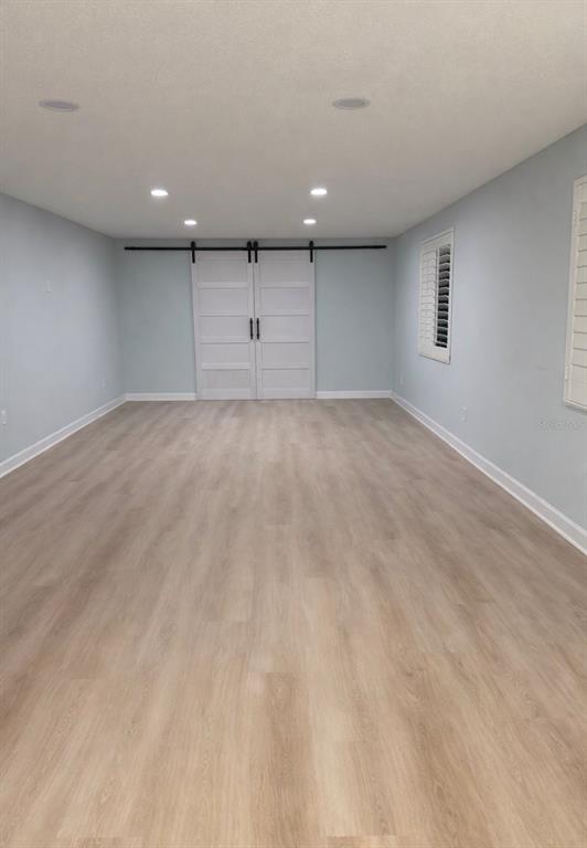 676 El Centro Longboat Key, FL 34228 - Photo 2 of 6 an empty room with a cabinet and mirrors
