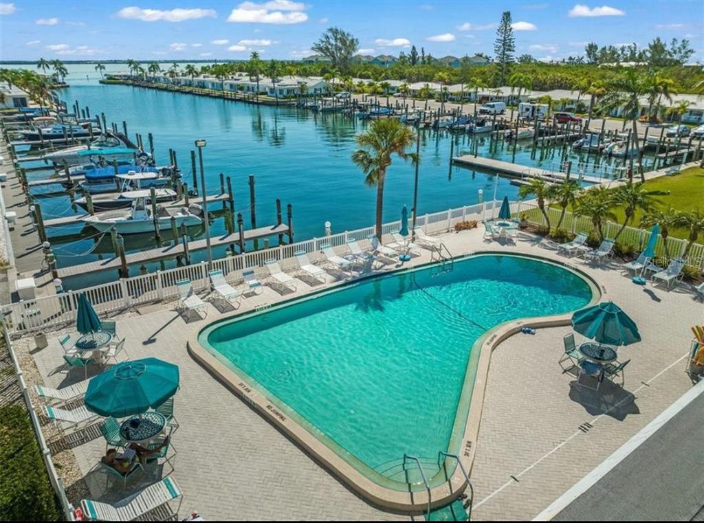 676 El Centro Longboat Key, FL 34228 - Photo 6 of 6 swimming pool with outdoor seating and lake view