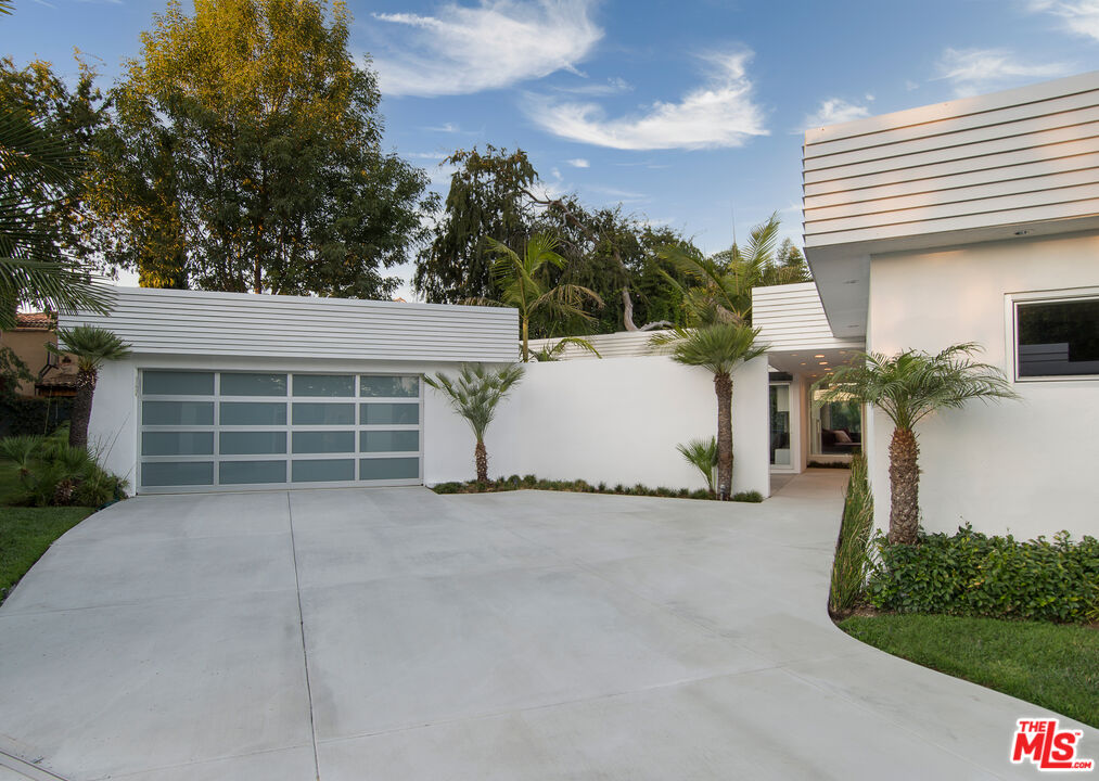 1466 Bel Air Road Los Angeles, CA 90077 - Photo 33 of 35 a view of a house with a yard and garage
