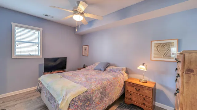 a bedroom with a bed and a dresser in it