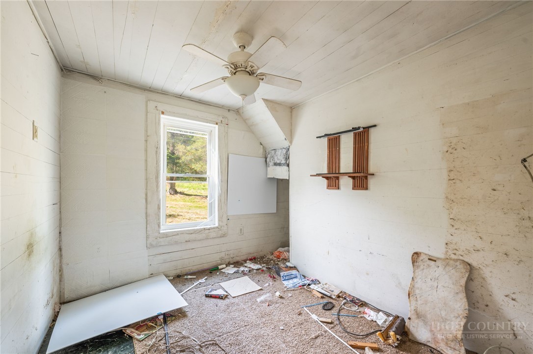 657 Lawrence Greene Road Deep Gap, NC 28618 - Photo 23 of 25 a bedroom with a bed and wooden floor