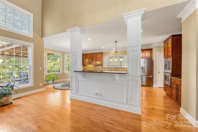 a view of a kitchen with furniture and wooden floor