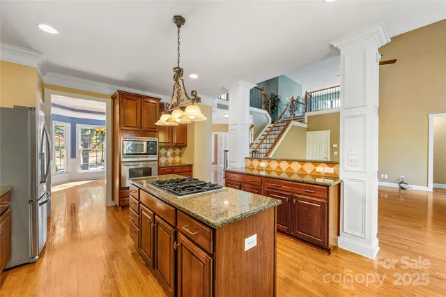 a kitchen with stainless steel appliances granite countertop a stove and a refrigerator