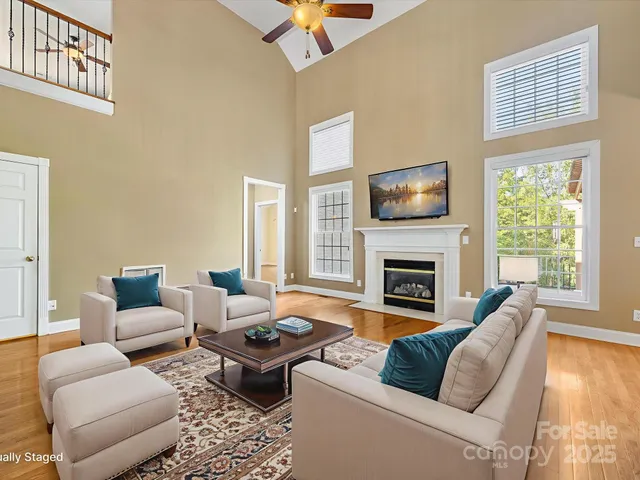 a living room with furniture a fireplace and a flat screen tv