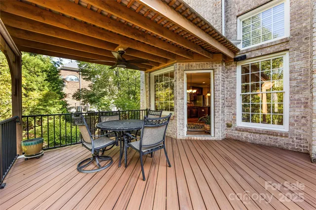 a view of a patio with table and chairs and wooden floor