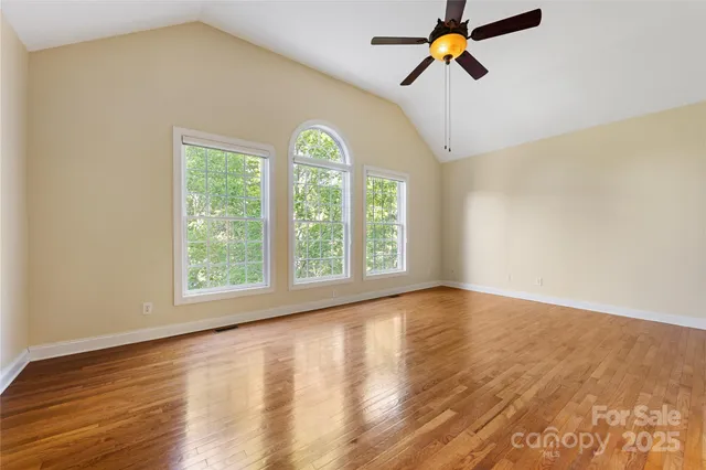 a view of a room with window and a ceiling fan