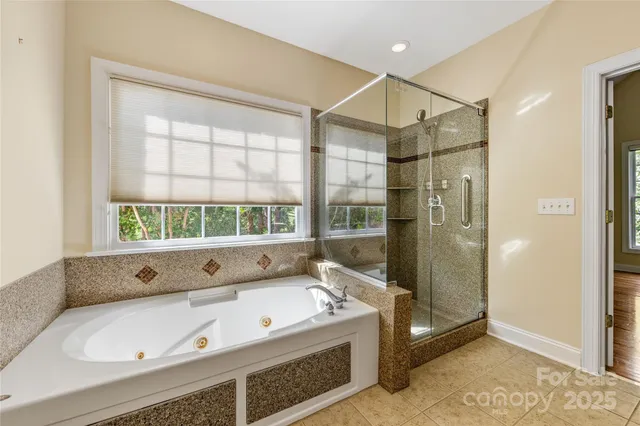 a bathroom with a tub and a shower