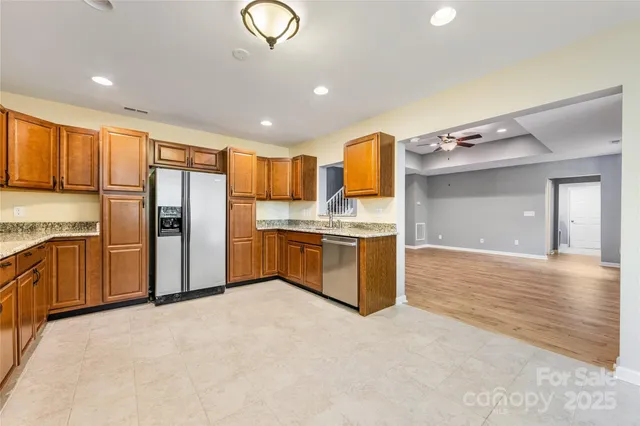 a kitchen with stainless steel appliances a refrigerator and microwave