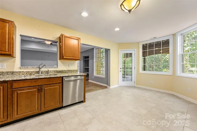 a spacious bathroom with a granite countertop sink and a large mirror