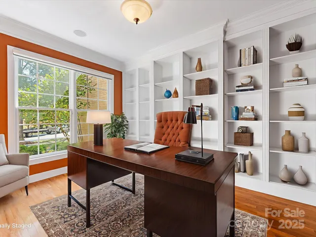 a view of a workspace with furniture and a window