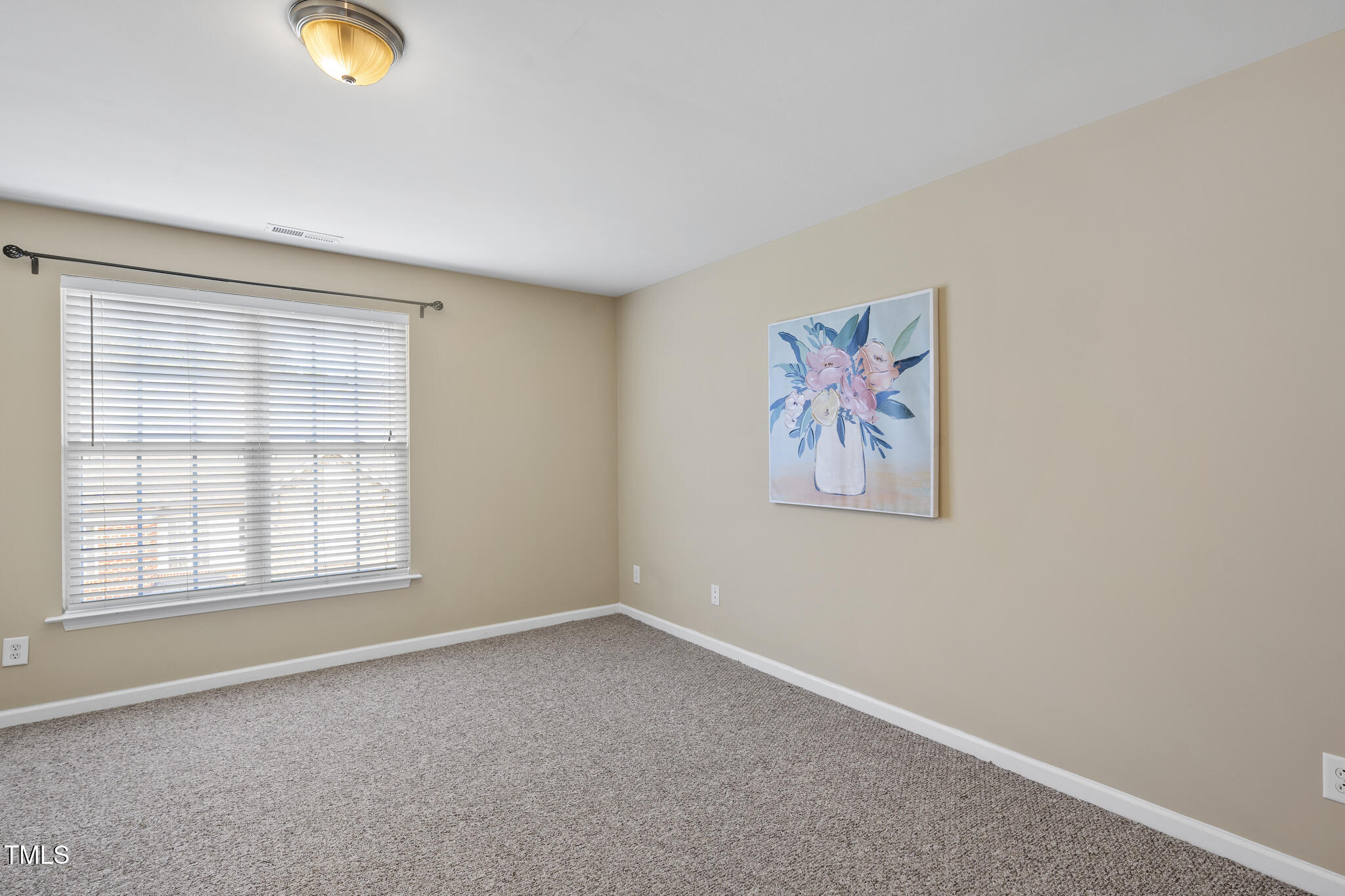 9910 Clyborn Court Raleigh, NC 27617 - Photo 14 of 19 an empty room with window and painted walls