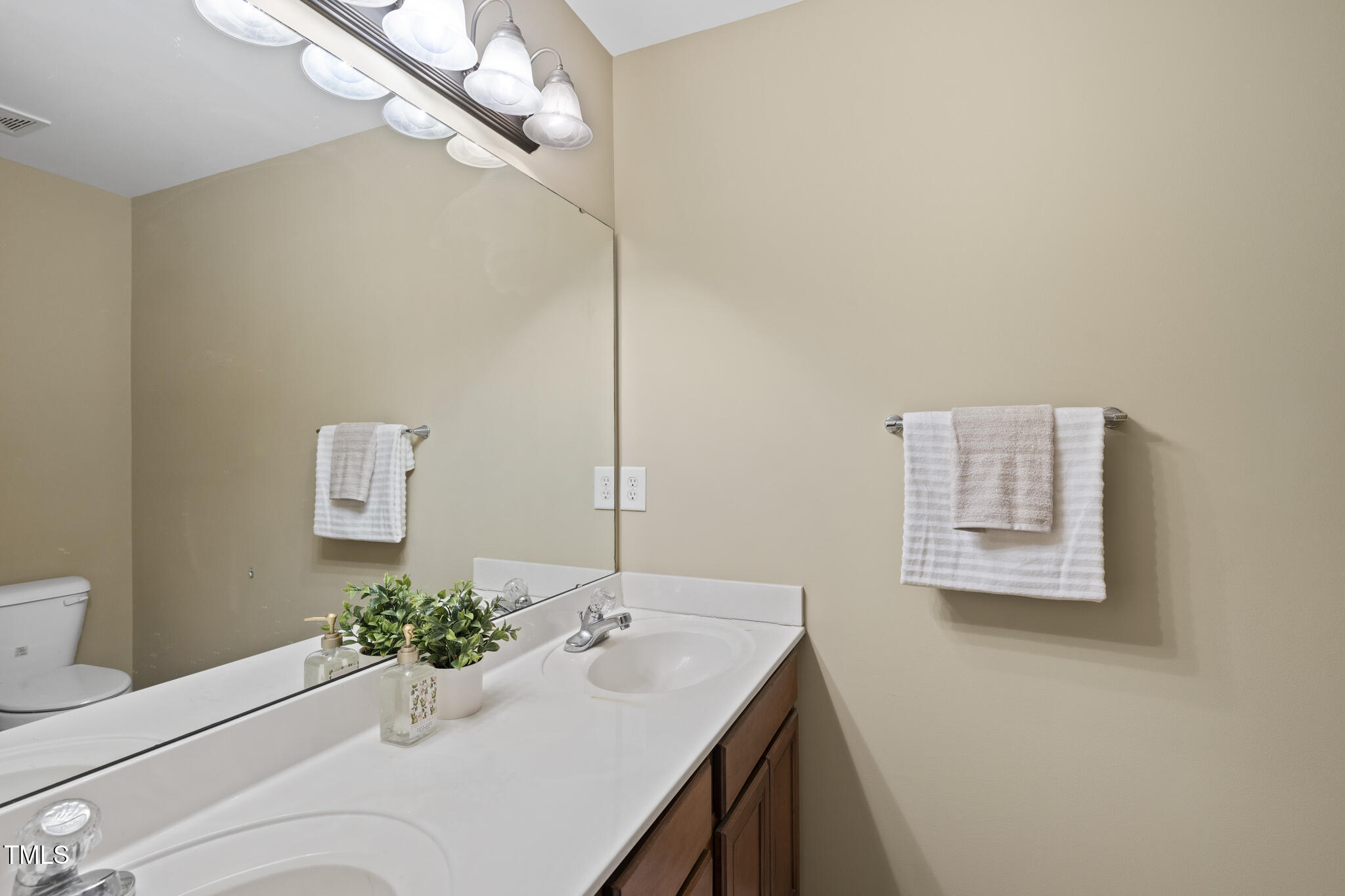 9910 Clyborn Court Raleigh, NC 27617 - Photo 15 of 19 a bathroom with a sink and a mirror