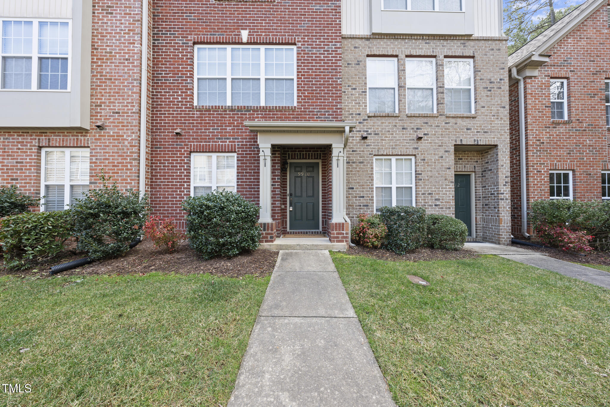 9910 Clyborn Court Raleigh, NC 27617 - Photo 2 of 19 front view of a brick house with a yard